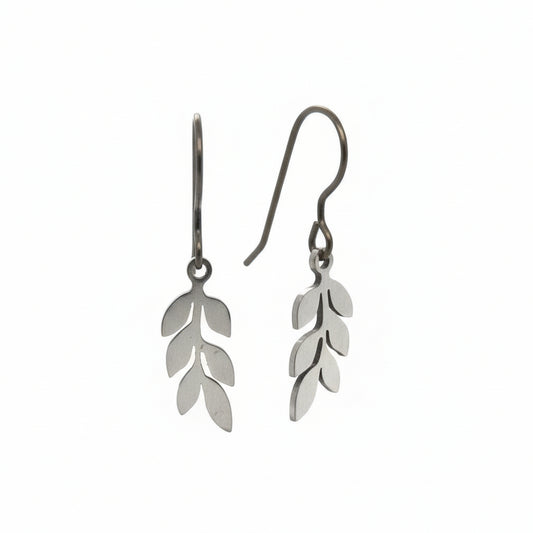 A pair of dangle earrings with leaf-shaped metal charms attached to hooks, displayed against a white background.