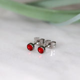 Titanium stud earrings, bezel set crystals, red