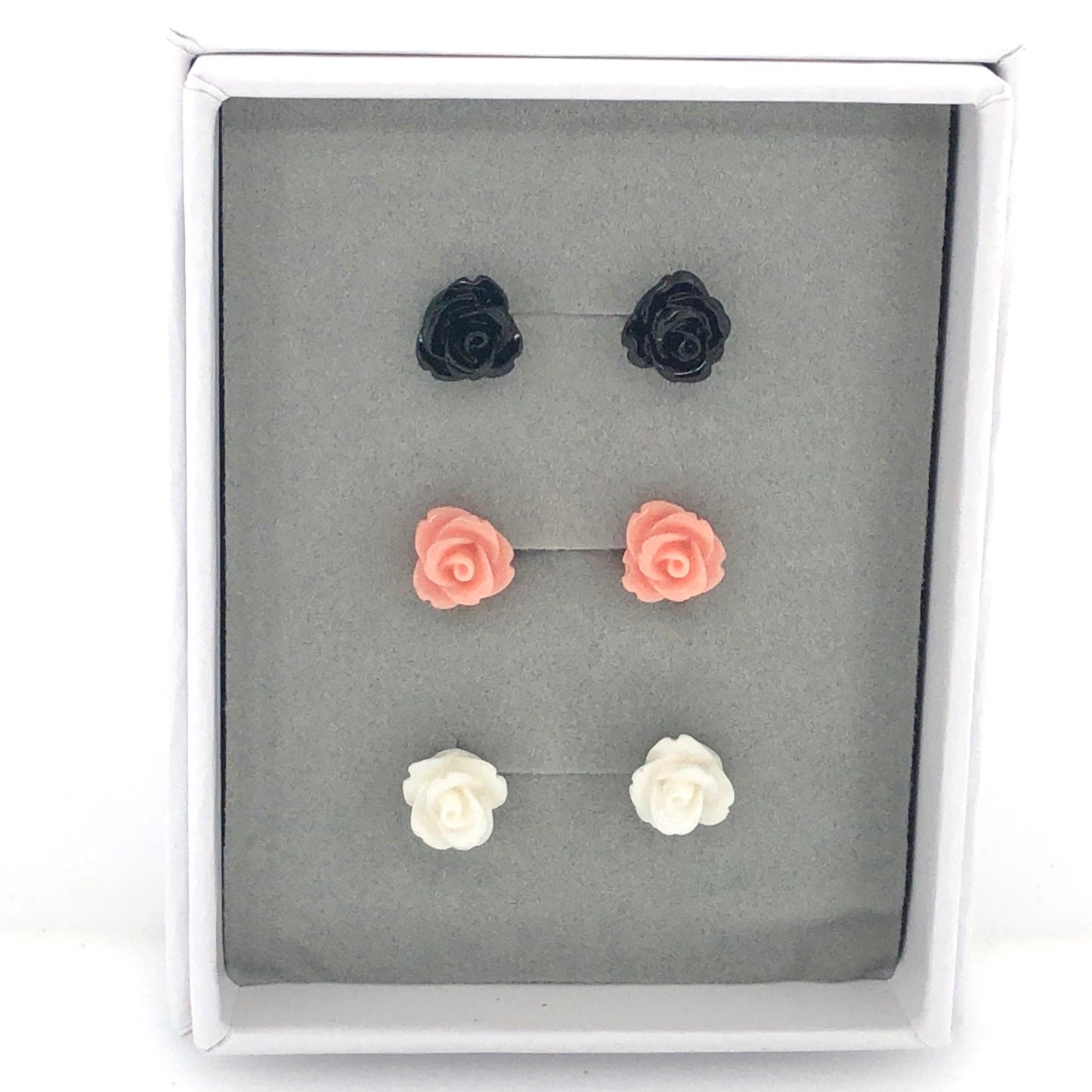 A set of rose stud earrings in various colors including black, pink, and white, presented in a gift box.