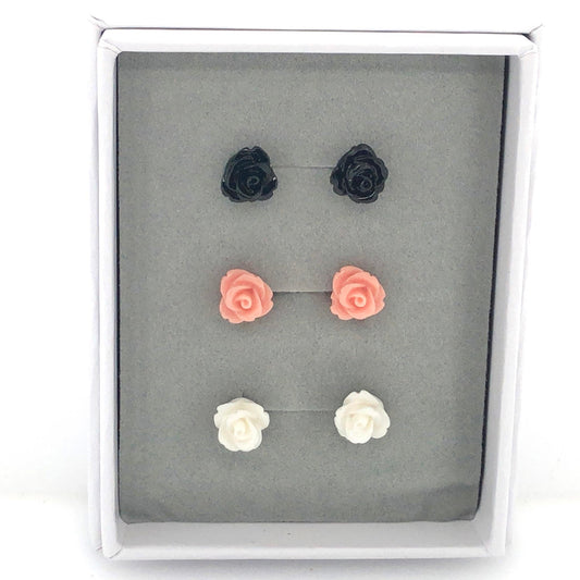 A set of rose stud earrings in various colors including black, pink, and white, presented in a gift box.