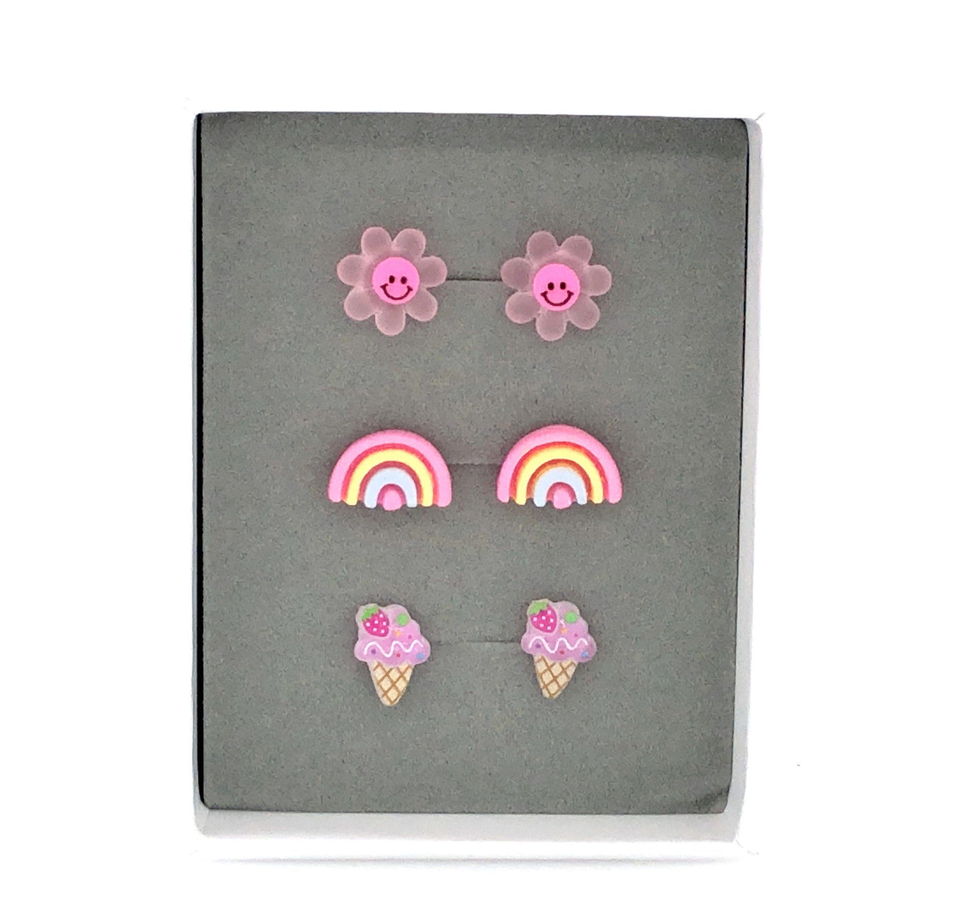 Three pairs of earrings featuring a dark pink smiley face daisy, a pink rainbow, and a purple ice cream cone design, presented in a box 