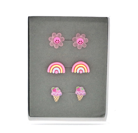 Three pairs of earrings featuring a dark pink smiley face daisy, a pink rainbow, and a purple ice cream cone design, presented in a box 