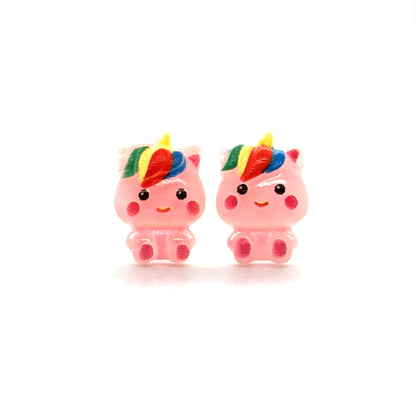 A pair of pink unicorn stud earrings with rainbow-colored manes, crafted from resin, displayed against a white background.