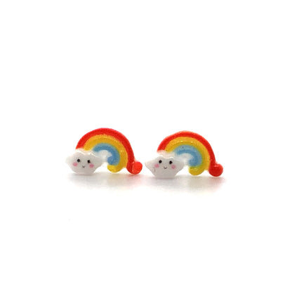 A pair of dainty rainbow-shaped stud earrings with a small cloud design on a white background.