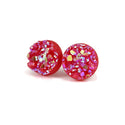 A pair of red faux druzy stud earrings embedded with multicolored crystals, displayed against a white background.