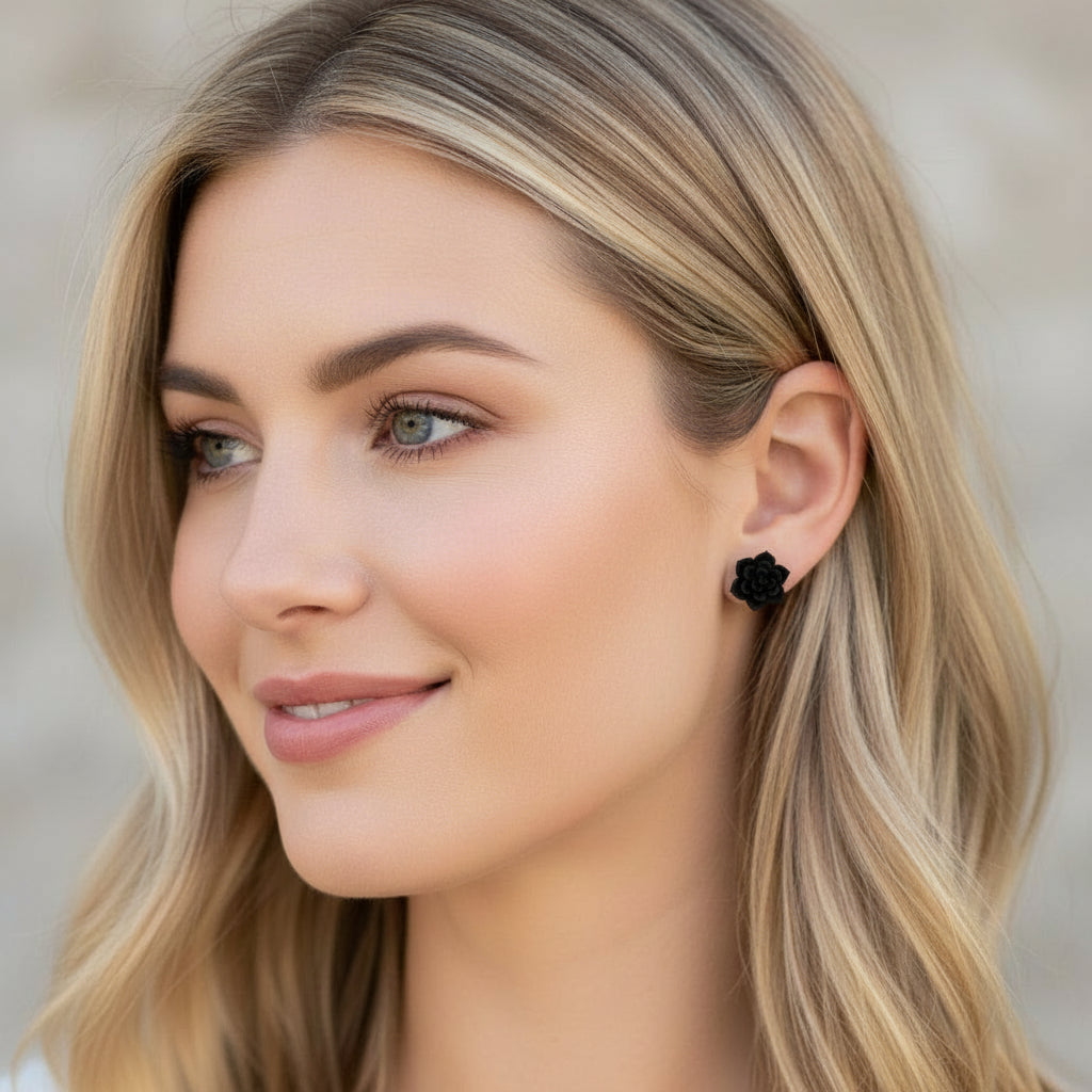 Red floral earring worn by a person with blonde hair.