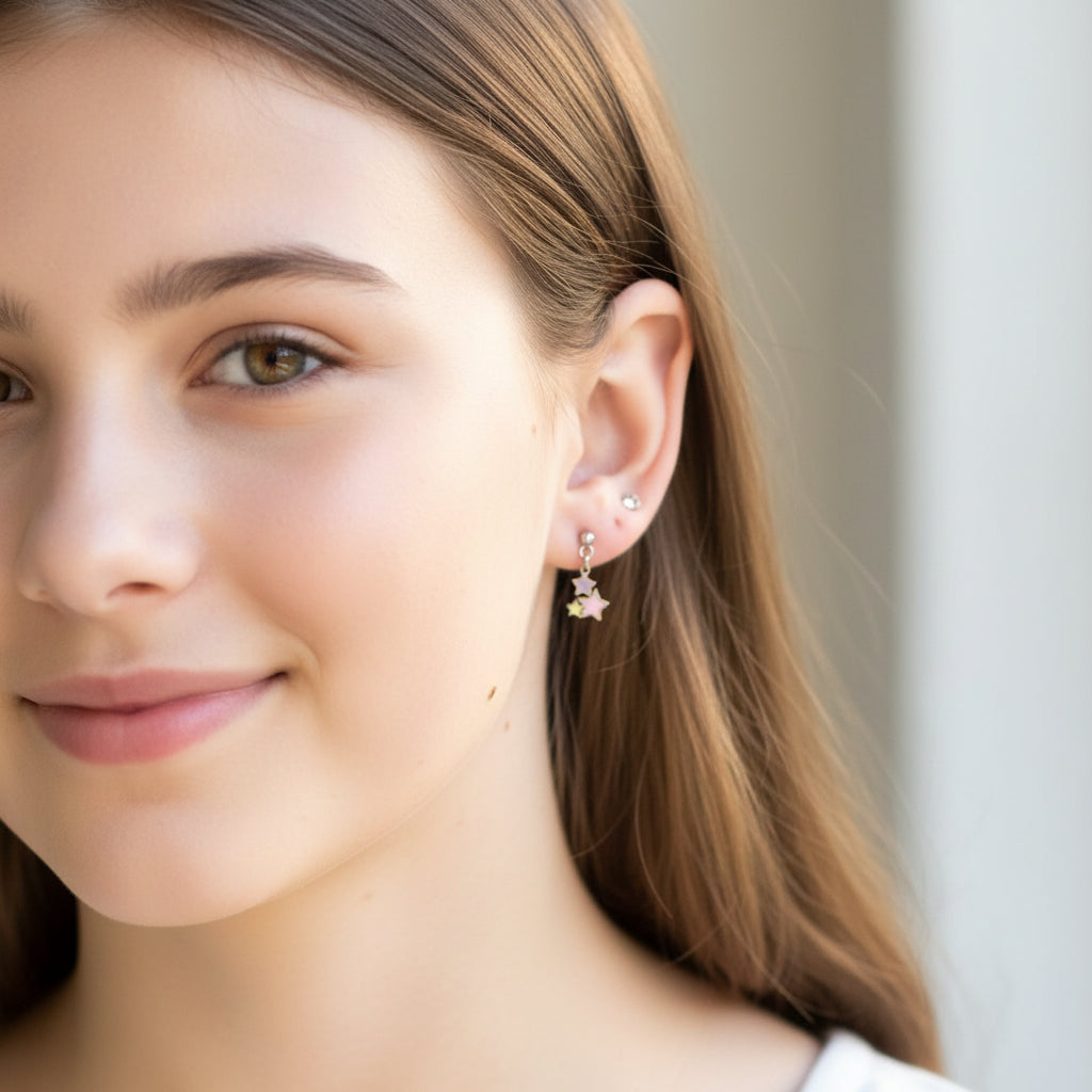 Close-up of an ear with a colorful star-shaped earring.