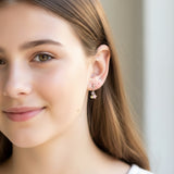 Close-up of an ear with a colorful star-shaped earring.
