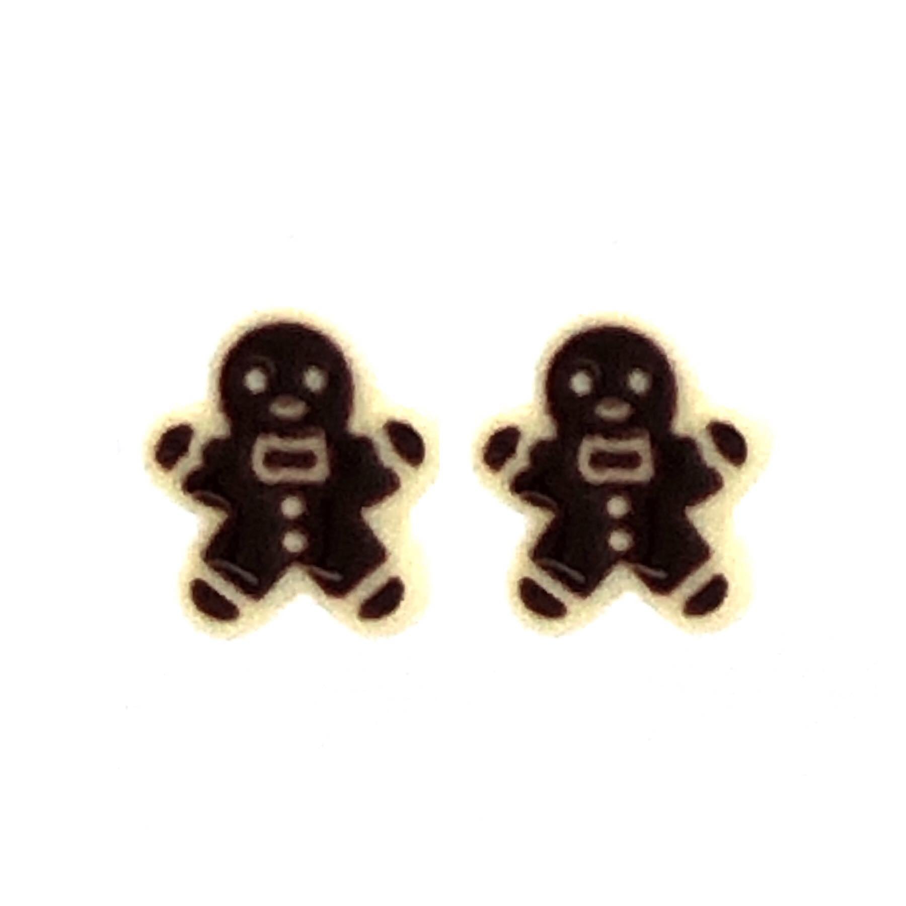 A pair of gingerbread man-shaped stud earrings in a two-tone color scheme, with a white background.
