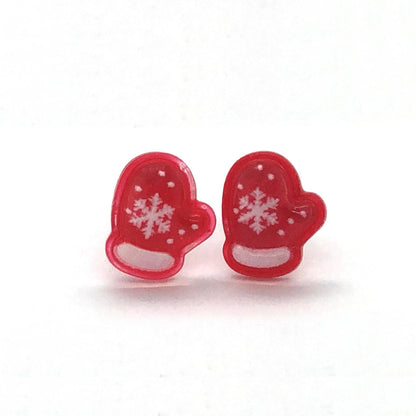 A pair of red mitten-shaped stud earrings with white snowflake patterns on them.