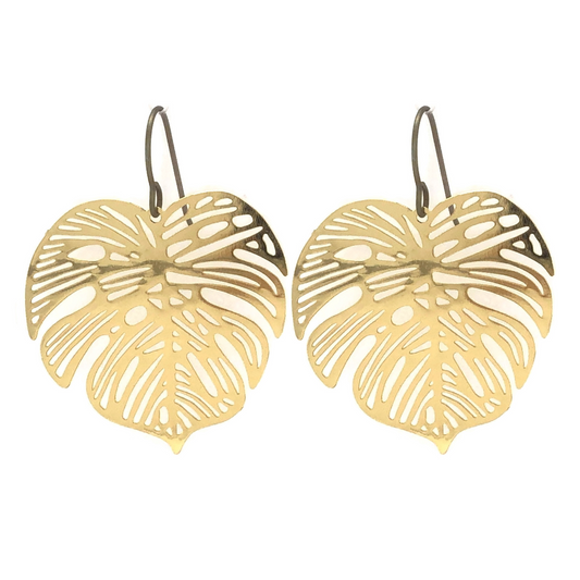 A pair of gold-colored dangle earrings designed in the shape of a Monstera leaf.