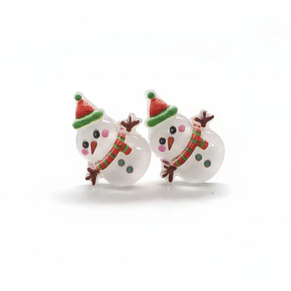 A pair of snowman-shaped stud earrings with colorful accents on the hat and scarf, made of resin, displayed against a white background.