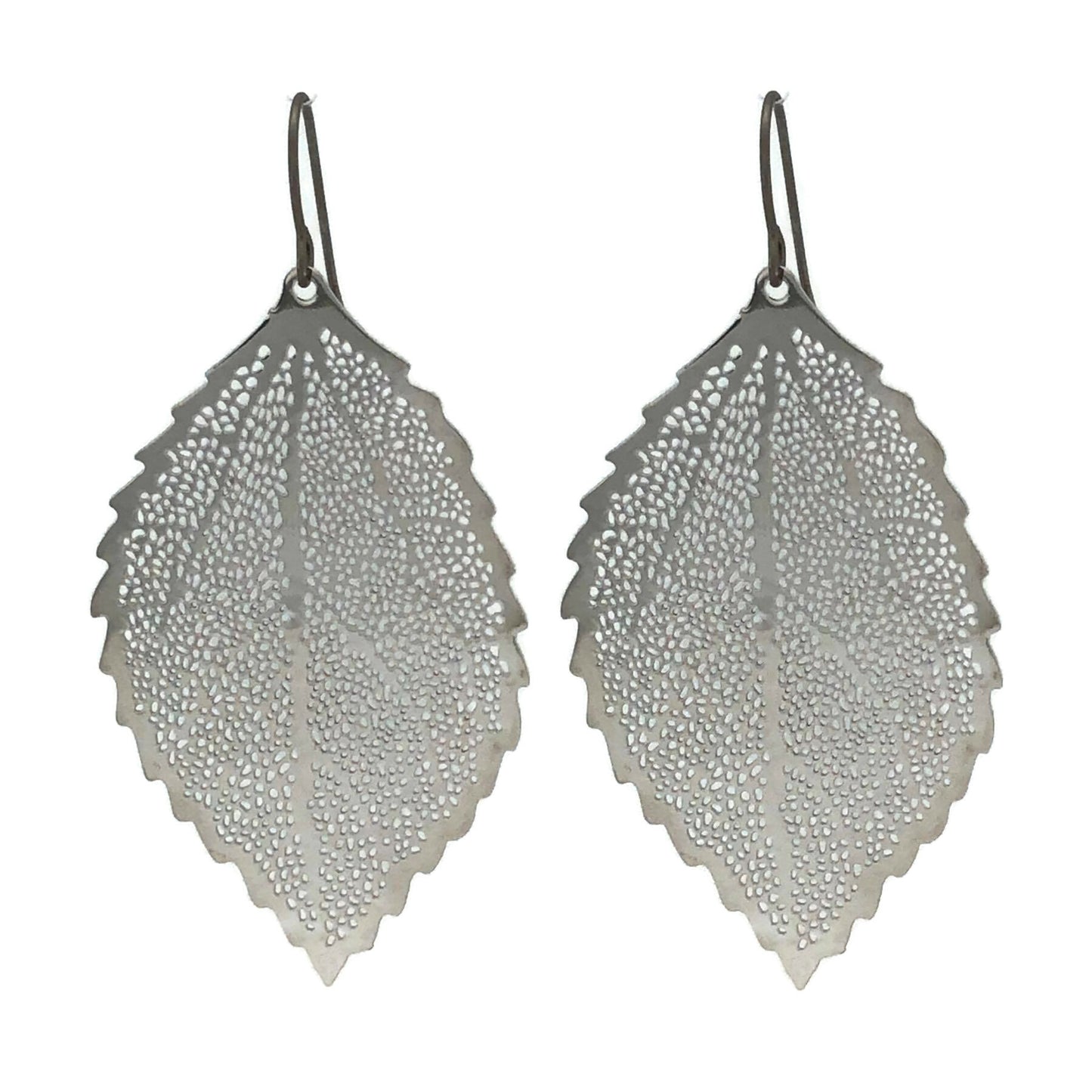 A pair of silver dangle earrings designed to resemble a leaf, with a textured surface and rounded edges.