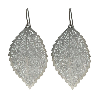 A pair of silver dangle earrings designed to resemble a leaf, with a textured surface and rounded edges.