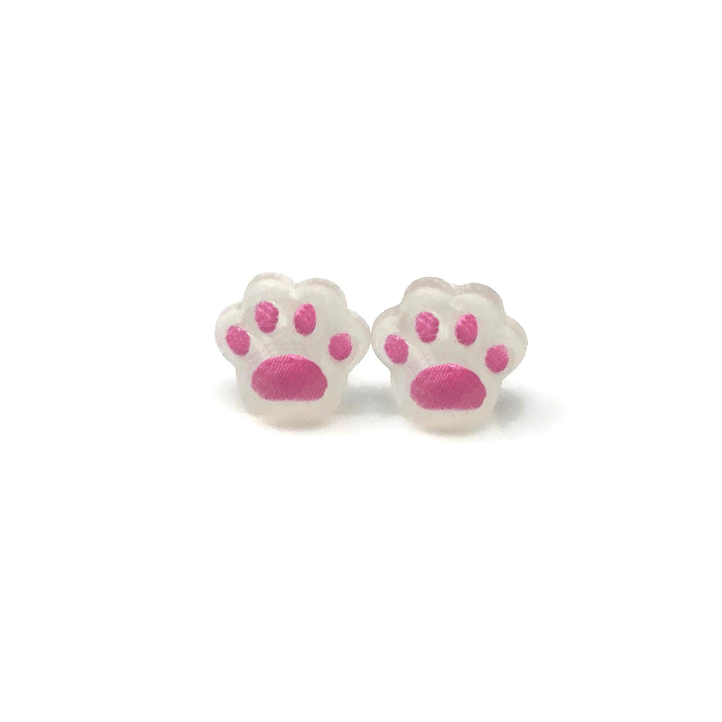 A pair of dainty paw print-shaped stud earrings in a beige color with brown details on a white background.