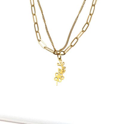 gold color paperclip necklace layered with a curb chain and hawthorne may birthmonth flower necklace