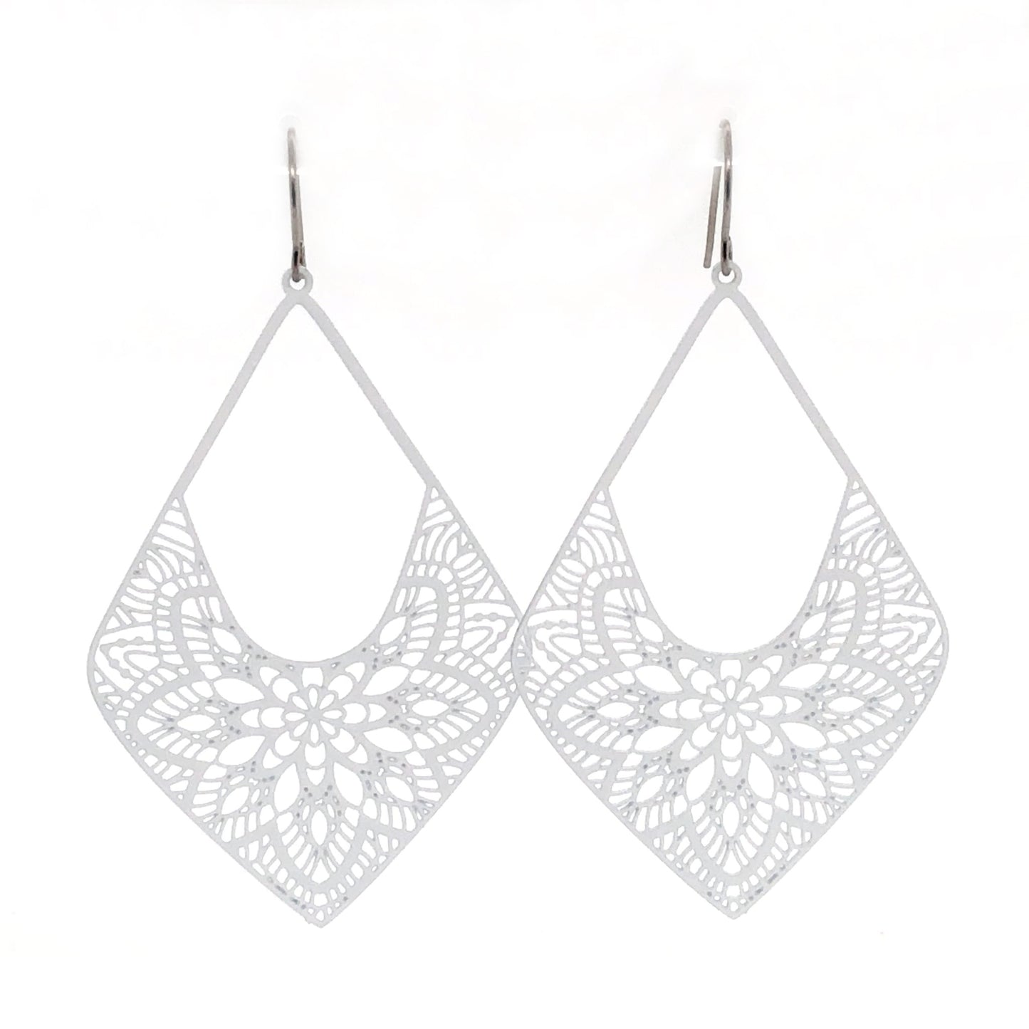 A pair of white lace diamond-shaped dangle earrings with invisible clip-on attachments.