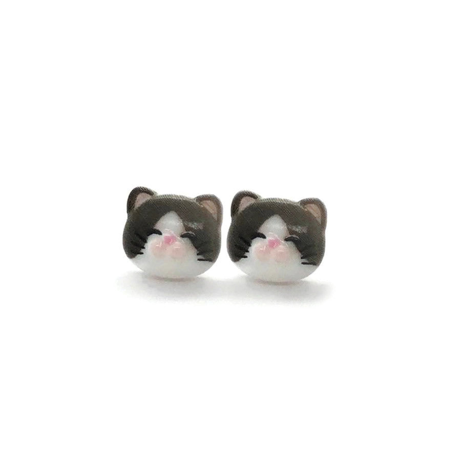 A pair of cat-themed stud earrings made of resin, featuring a simple solid black color with white and pink details for the ears.