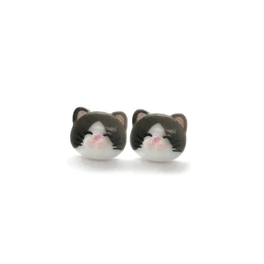 A pair of cat-themed stud earrings made of resin, featuring a simple solid black color with white and pink details for the ears.