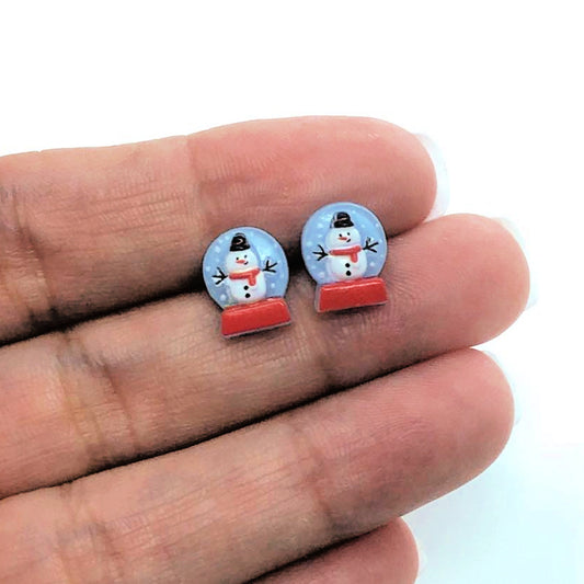 snowbglobe earrings in a hand