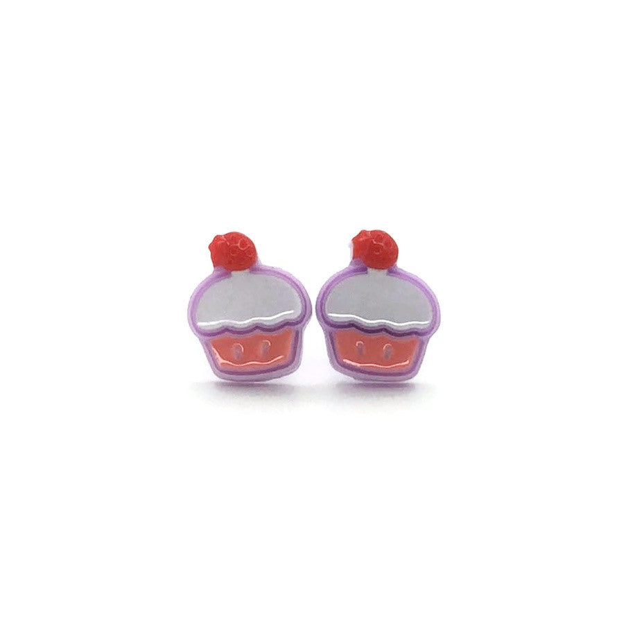 A pair of cupcake-shaped stud earrings in purple with a red cherry on top, made of resin, displayed against a white background.