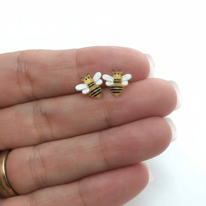 bee earrings in a hand
