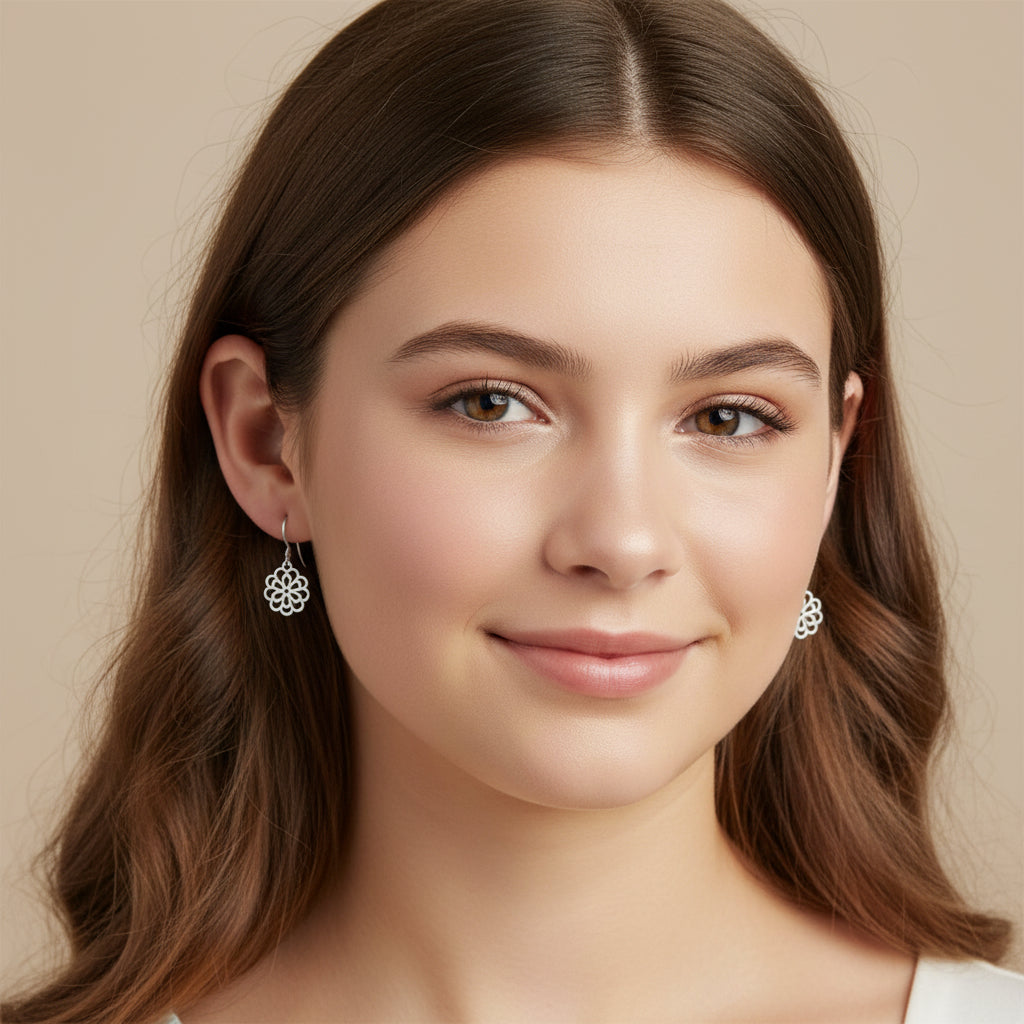 Close-up of a person wearing a floral silver earring with blurred background