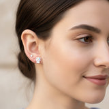 Close-up of an ear with a unicorn-shaped earring.