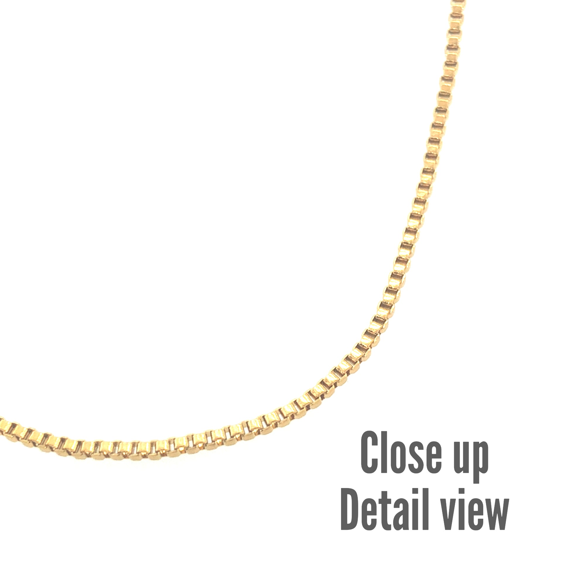 Close-up detail view of a gold-colored box chain necklace with a smooth, polished finish.