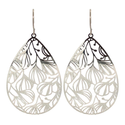 A pair of silver floral filigree teardrop dangle earrings with a polished stainless steel finish, designed for invisible clip-on wear.