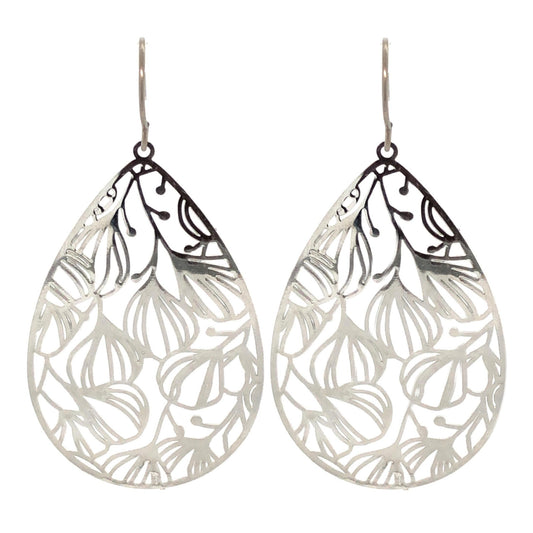 A pair of silver floral filigree teardrop dangle earrings with a polished stainless steel finish, designed for invisible clip-on wear.