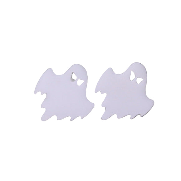 Ghost-shaped earrings on a reflective surface with a blurred green background
