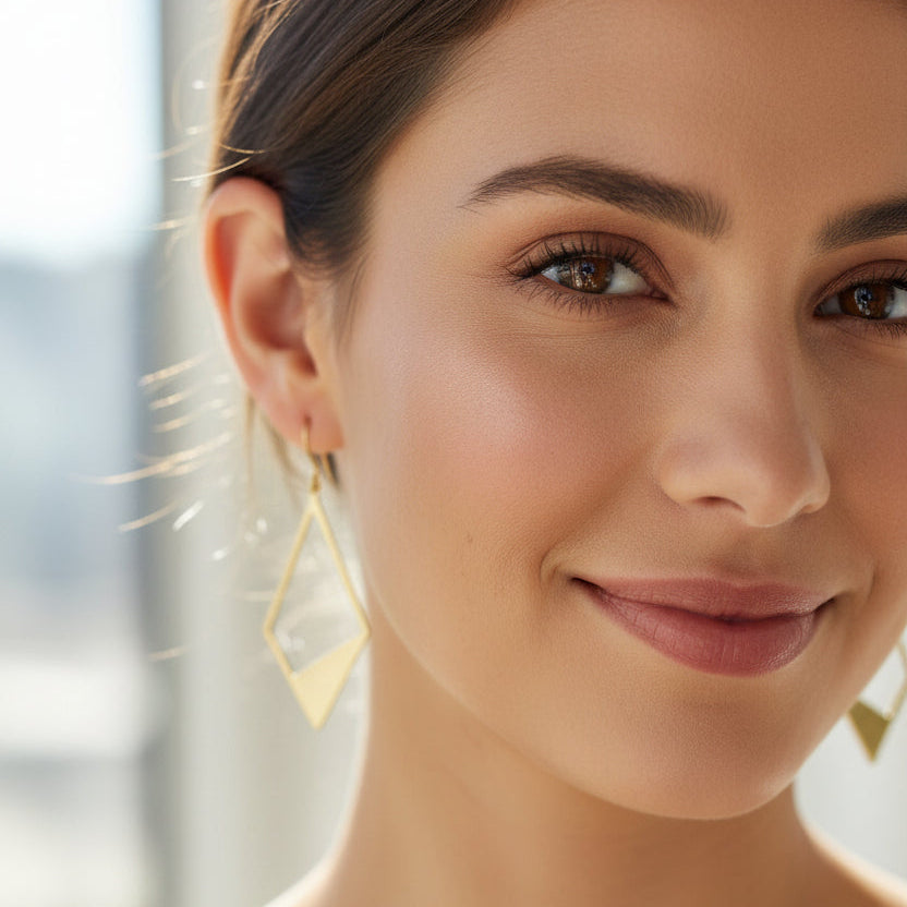 Gold geometric earring on a white background