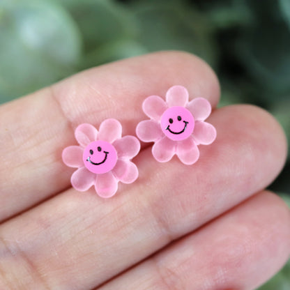pink smiley face flower in hand
