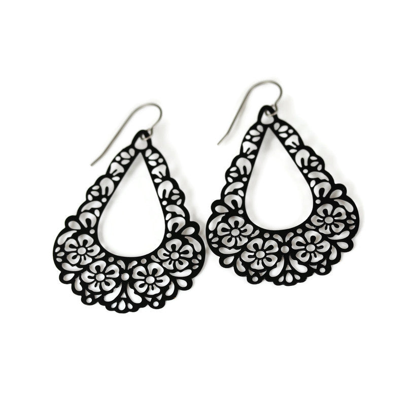 A pair of black floral filigree teardrop dangle earrings.