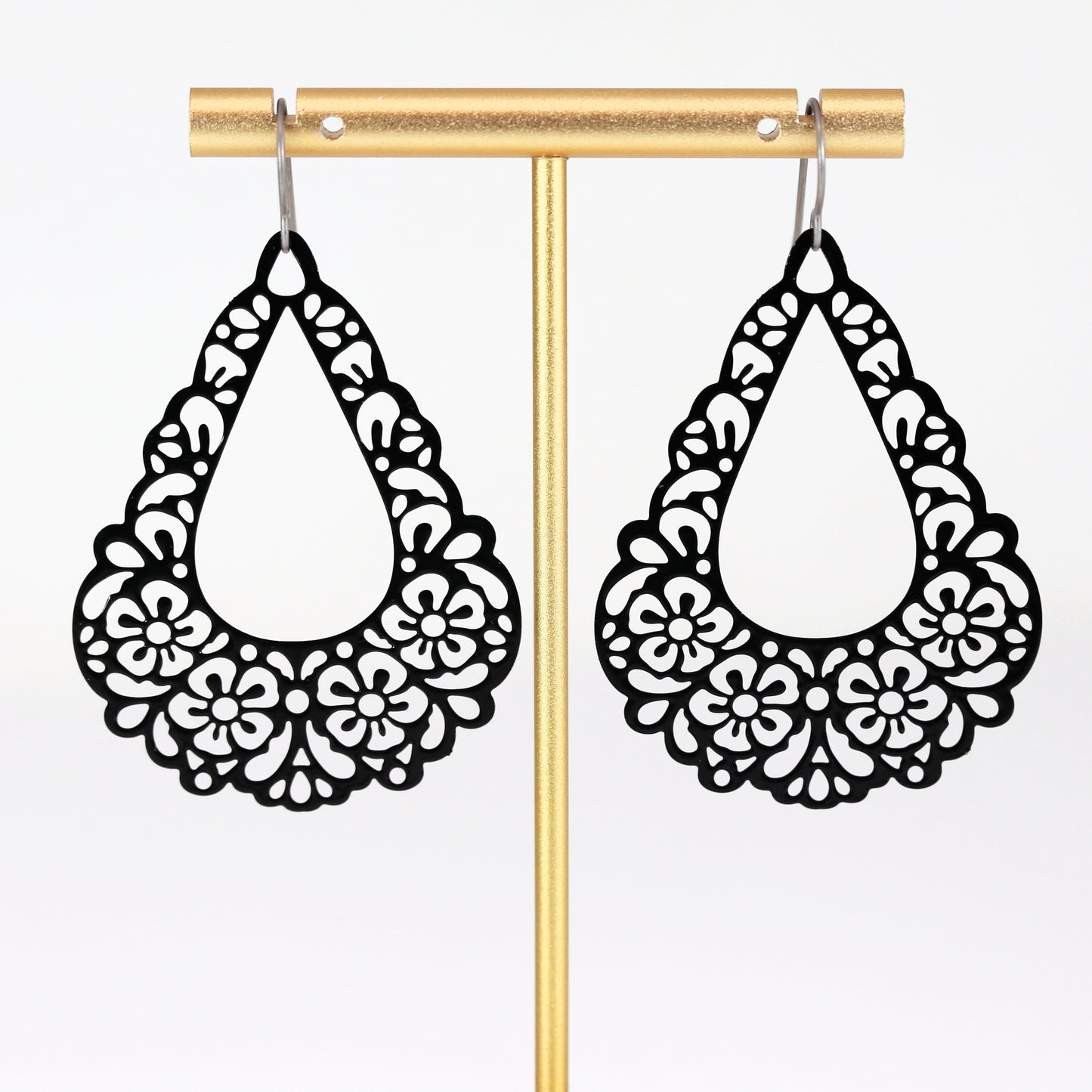black floral earrings dangle on titanium hooks