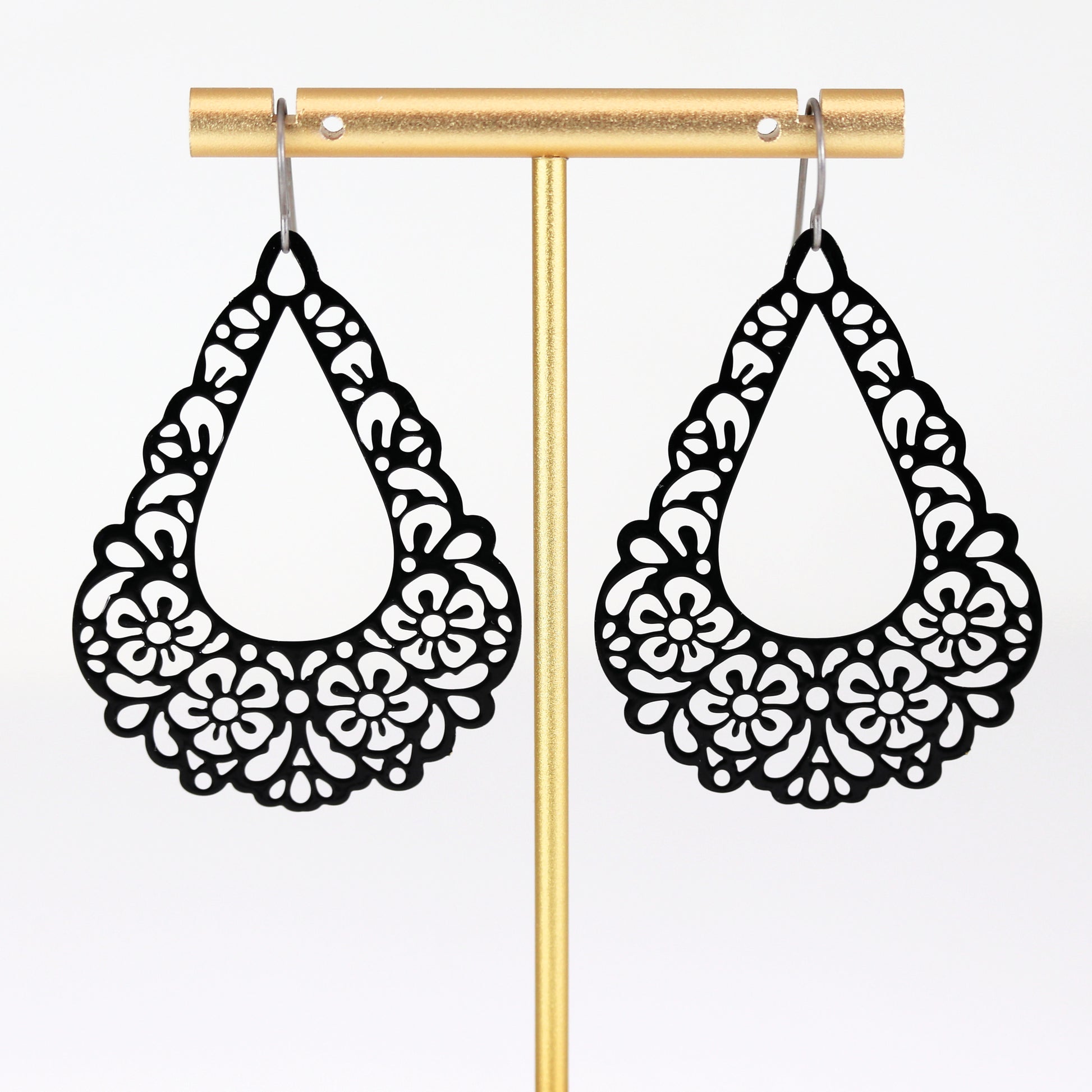 black floral earrings dangle on titanium hooks