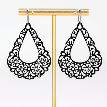 black floral earrings dangle on titanium hooks