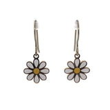 A pair of dangle earrings featuring a white and yellow daisy design on a silver hook.