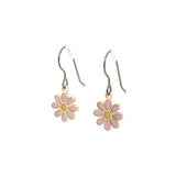 A pair of dangle earrings featuring a pink and yellow daisy design on a silver hook.
