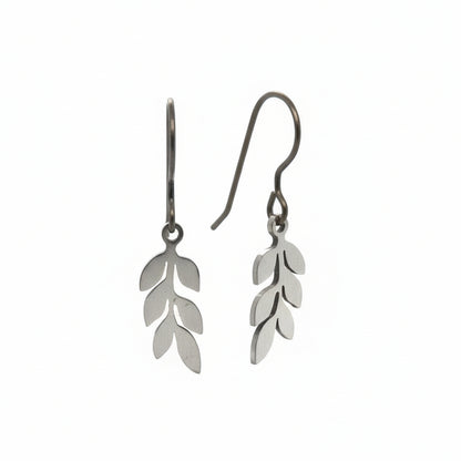 A pair of dangle earrings with leaf-shaped metal charms attached to hooks, displayed against a white background.