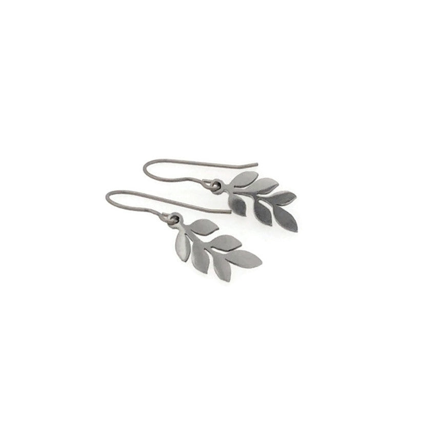 Silver leaf-shaped earrings on a white background