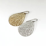 Gold Tone earring next to Silver tone earring