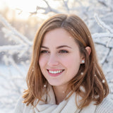 Close-up of an ear wearing a stud earring a clear glitter cabochon.