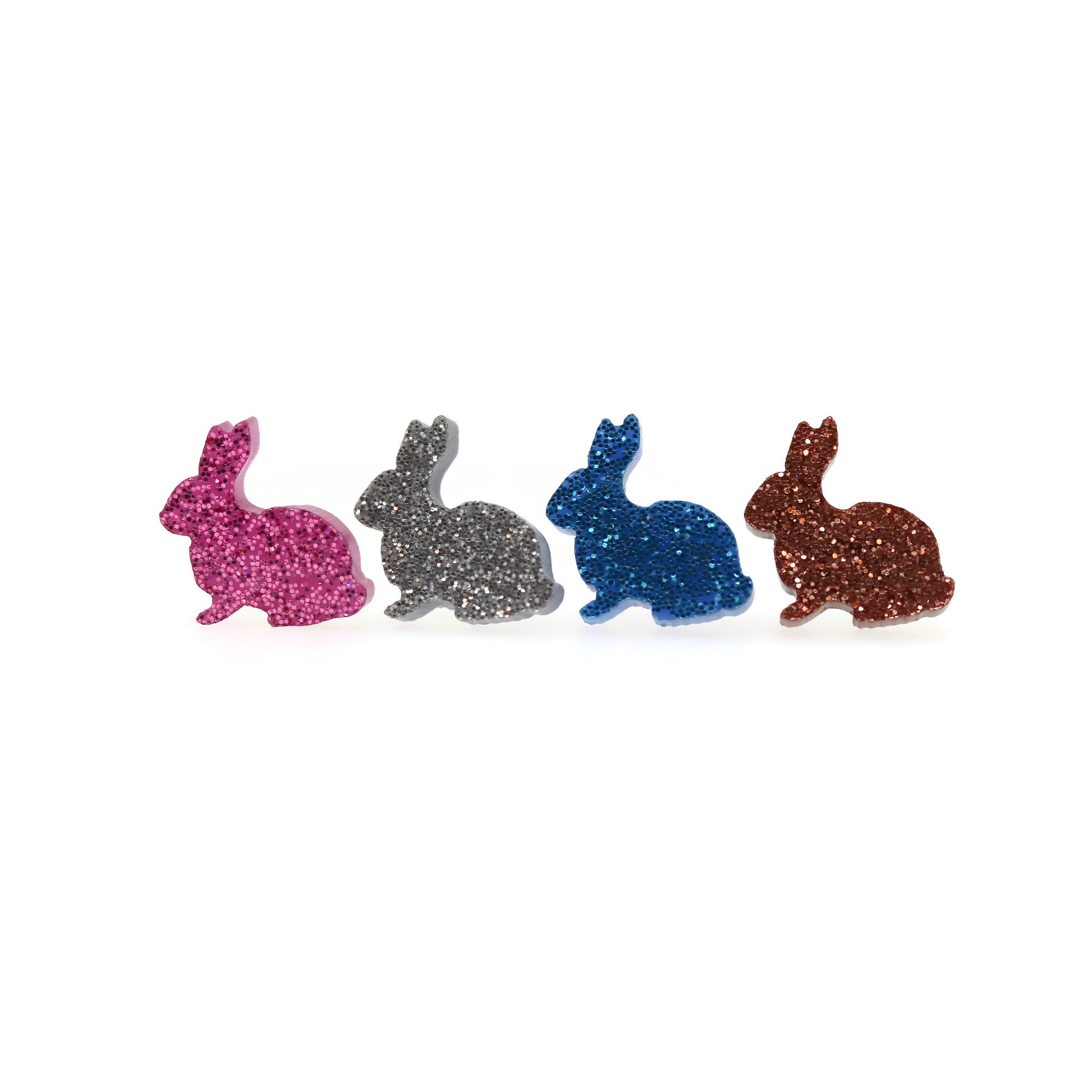 A set of glittery bunny-shaped stud earrings in pink, blue, and brown colors.