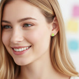 yellow ice pop earrings in an ear