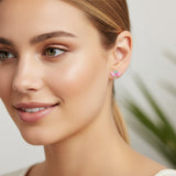 pink green dragonfly earring in an ear