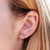 Close-up of an ear wearing reindeer earrings 