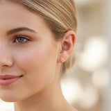 pink flower earring in an ear