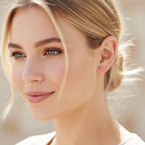 6mm coral flower clip on earring on an ear